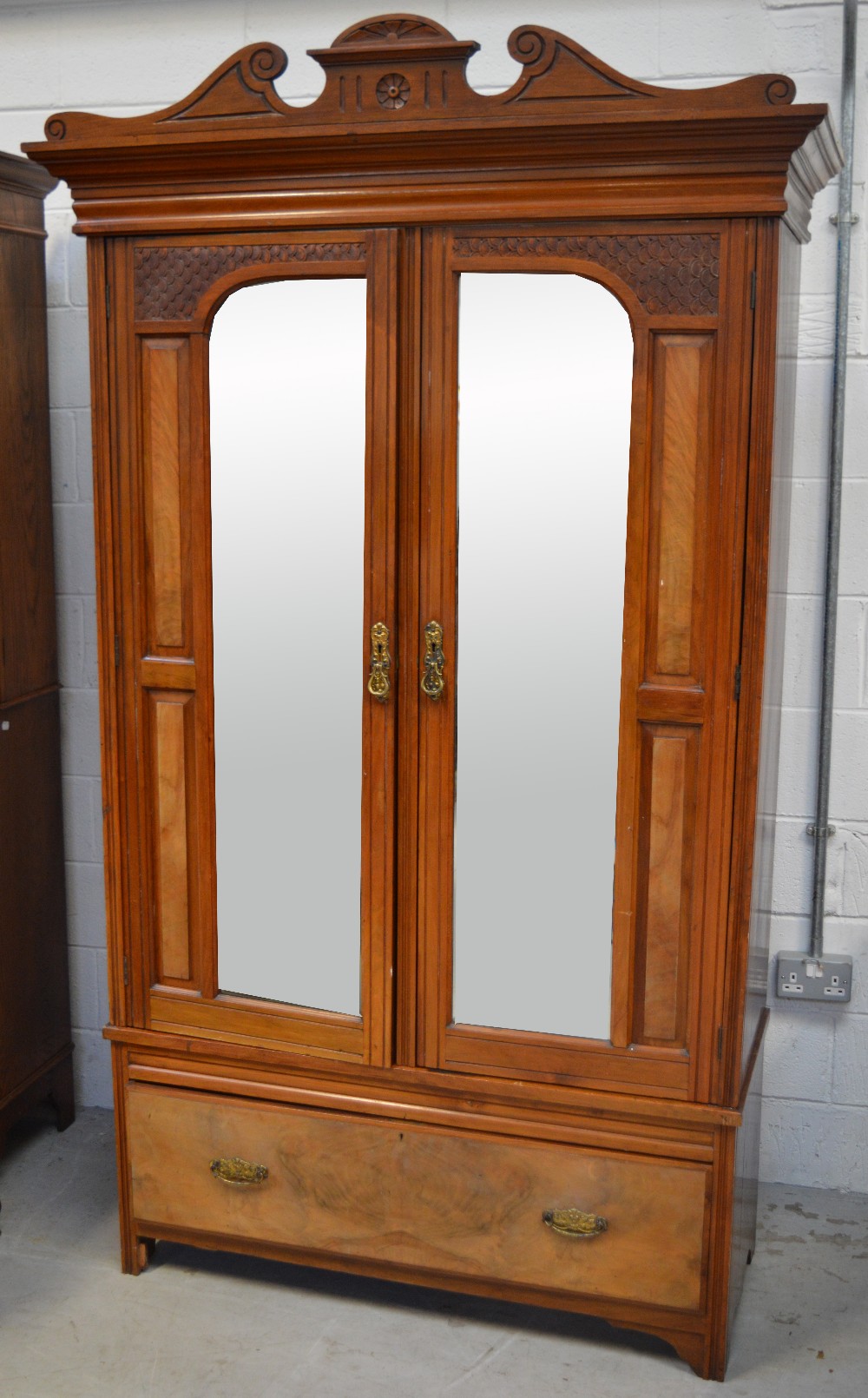 An Edwardian walnut wardrobe, width 112cm and a matching mirror back dressing table,