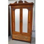 An Edwardian walnut wardrobe, width 112cm and a matching mirror back dressing table,
