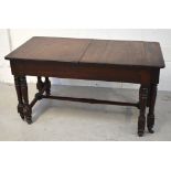 A 19th century rectangular mahogany extending dining table on turned supports and cross stretcher