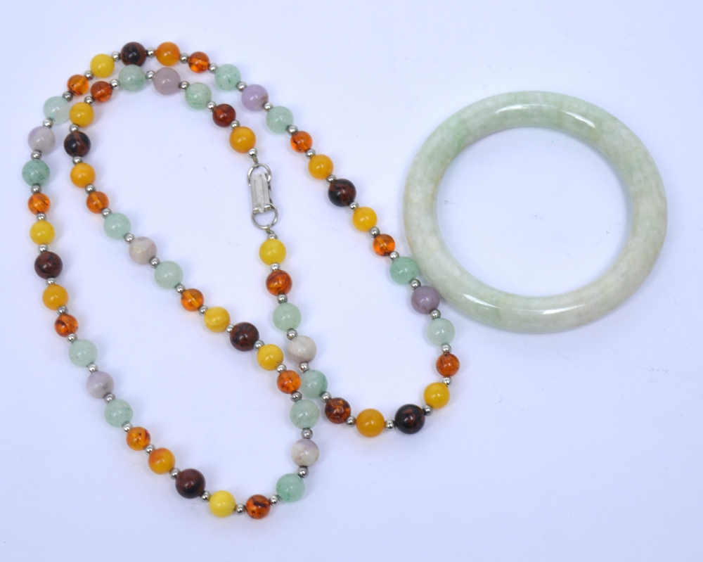 A polished jade bangle and a similar polished hardstone necklace (2).
