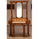 An Edwardian oak Arts and Crafts style hall stand, central mirror above marble top,