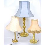 Three brass table lamps of varying designs, to include a column lamp and a turned column lamp,