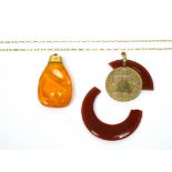 A 9ct gold mounted amber pendant with 9ct yellow gold chain and a similar amber-coloured yellow