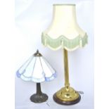 A brass-effect classical style column table lamp and a modern Art Deco style lamp with Tiffany