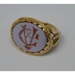 A carnelian set gentlemen's signet ring in unmarked yellow metal,