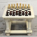 A freestanding cream painted wooden chess board,