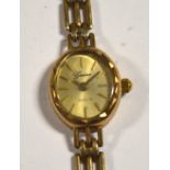 A 9ct gold ladies' wristwatch with 9ct gold link strap, the gilded dial set with baton numerals,