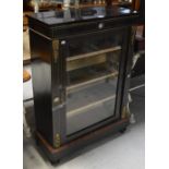 An early Victorian ebonised and inlaid pier cabinet with a single glazed door,