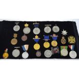 A quantity of medals and badges to include a WWII defence medal etc.