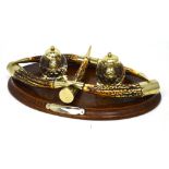An early 20th century desk set on an oval oak base with five horn decoration,