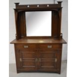 An Arts & Crafts oak mirror back dresser, pierced stylised pediment above central bevel edge plate,