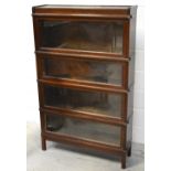 An oak Globe-Wernicke style four-section bookcase on square supports, height 142cm.