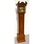 A mid-20th century oak cased grandmother clock, the gilded dial set with Roman numerals,