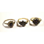 A yellow metal dress ring set with nine midnight blue stones, size Q,