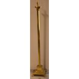 A brass reeded column standard lamp on a square stepped base and paw feet, height 143cm.