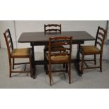An Ercol style refectory style dining table raised on twin end slab supports,