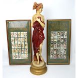 A large metal painted figurine of a semi-nude Grecian maiden,