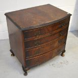 A mahogany bow-front four-drawer chest of drawers with brass handles on cabriole legs,