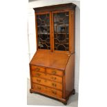 A mahogany bureau bookcase with two astragal glazed doors with integral shelving above fitted