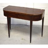 A 19th century mahogany inlaid fold-over card table on tapering supports and peg feet,