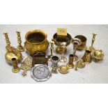 A quantity of brassware to include jugs, pedestal bowl, brass kettle, candlesticks etc.