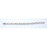 An 18ct white and yellow gold oval link bracelet set with small diamonds,