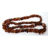 An amber-coloured necklace, length 72cm.