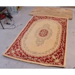 Two rugs; a red and cream ground Indian rug and a contemporary caramel ground rug (2).