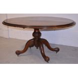 A Victorian oval walnut loo table, raised on carved quadripartite base, width 146cm.