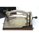 A small 'Ideal' tabletop sewing machine, UK Patent no.30264, with domed ebonised cover, width 25cm.