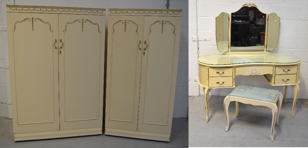 A retro cream bedroom suite in the French boudoir style comprising two matching twin door wardrobes,