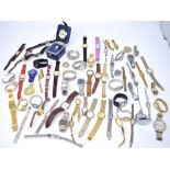 An extensive collection of approximately seventy ladies' and gentlemen's wristwatches, some boxed.