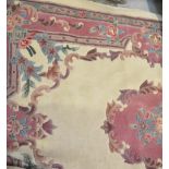 A wool Oriental style cream ground rug with pink and green floral decoration, 152 x 244cm.