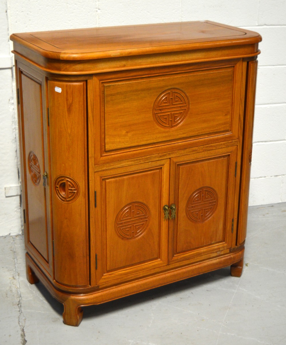 An Oriental hardwood cocktail cabinet with fully fitted interior, width 90cm.