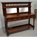 A Victorian mahogany mirror back sideboard with turned top rail over three drawers, shelf below,