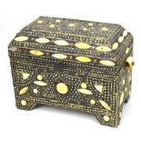 An Indian wood box inlaid with white stones and white metal studwork.