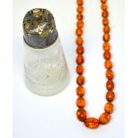 An amber-coloured bead necklace and a hallmarked silver mounted glass sifter (2).