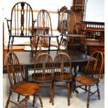 An Ercol style dining table, raised on twin end slab supports,