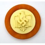 A 1938 Nazi ivory and amber coloured plastic swimming medal with gilt text verso,