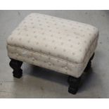A 19th century ebonised footstool upholstered in ivory fabric.