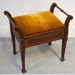 An Edwardian mahogany and inlaid piano stool with mustard upholstered lift-up seat on tapering legs,