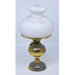 A Duplex brass oil lamp with opaque fluted white shade, height 50cm.