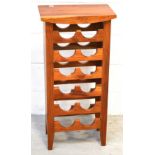 A modern pine freestanding wine rack to accommodate twelve bottles.