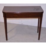 An Edwardian mahogany and inlaid fold-over tea table, on square section tapering legs,