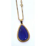 An 18ct gold box chain with lapis lazuli pear-shaped pendant in a yellow metal mount, approx 16g.