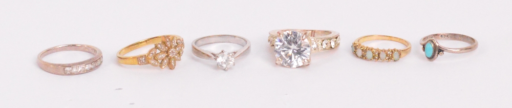 A small collection of dress rings including a 9ct yellow gold floral ring set with diamond chips,