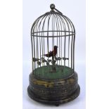 An early 20th century brass musical singing bird within a birdcage, within wirework dome,