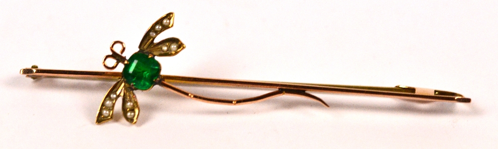 An Edwardian style 9ct gold dragonfly bar brooch set with an emerald body and seed pearl wings,