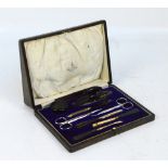 An early 20th century cased manicure set with faux tortoiseshell handled tools to include a nail