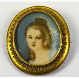 A 20th century oval portrait miniature of a young girl contained within a Victorian base metal